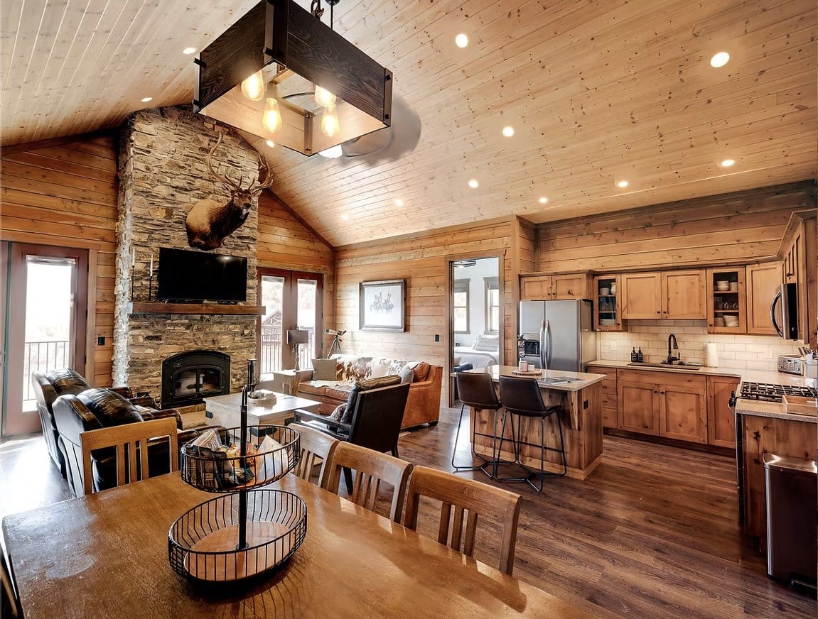 Open-plan living room with stone fireplace and kitchen