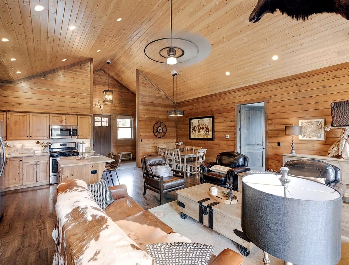 Lodge common area with wood paneling and cowhide furniture